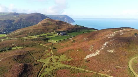 rural welsh heather covered mountain hillside valley ocean coastline aerial orbit right view
