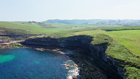 Aerial-drone-Top-Notch-side-view-of-El-Bolao-Cliff,-in-Cantabria,-summer-of-Northern-Spain