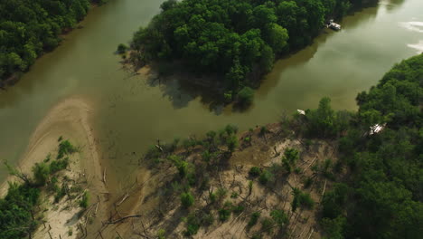 Tranquil-River-And-Lush-Vegetation-At-Twin-City-Riverfront-Park,-AR,-USA---aerial-shot