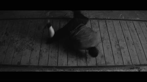 breakdancing performance on wooden floor