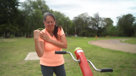 the woman unexpectedly felt shoulder discomfort while utilizing a hand pedal exerciser - close up