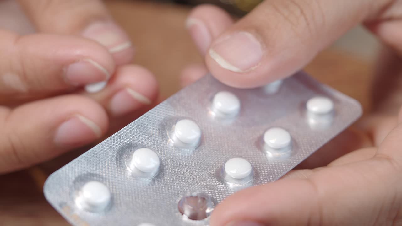 Hands holding blister pack of pills