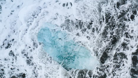 Stunning-drone-shot-of-surf-with-ice-rocks-at-Diamond-Beach-in-Iceland