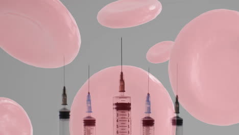 animación de glóbulos rojos y jeringas sobre un fondo gris