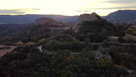 Aerial-views-of-the-path-to-historic-ruins-on-a-cliff-in-Osona,-Spain