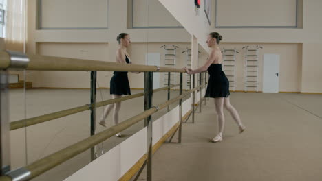 ballet dancer practicing at barre