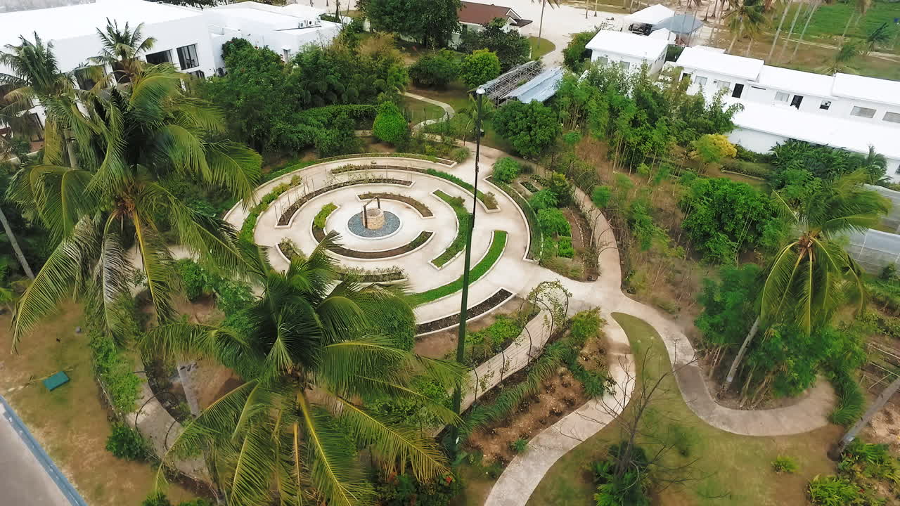 labyrinth circle with aviary dome for birdcage and palm trees behind science laboratory