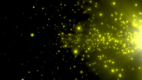 pequeñas partículas amarillas y estrellas en fondo oscuro