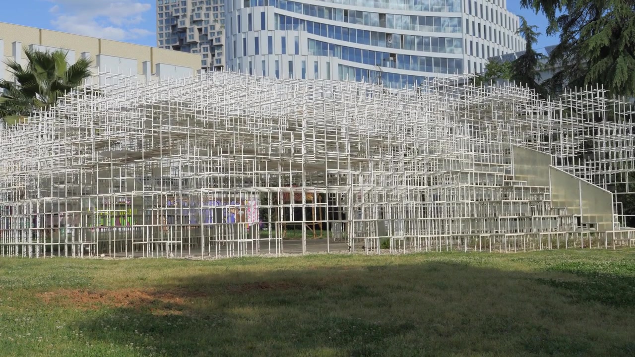 The Cloud pavilion lattice structure in Tirana Albania beside graffiti wall and tower