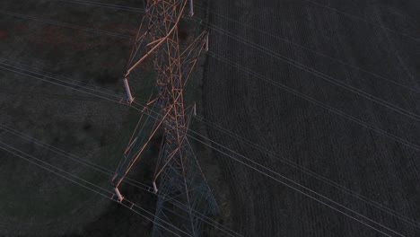 4k aerial power lines high voltage sunset pull back shot