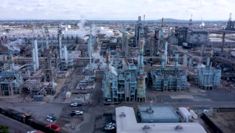 aerial drone footage of petroleum refinery and trucks in industrial area of the united states