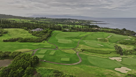 maui hawaii aerial v15 flyover kapalua plantation golf course capturing luxurious resort surrounded by lush green rolling fairways and mountain landscape views - shot with mavic 3 cine - december 2022