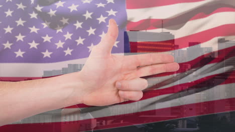 animation of caucasian hand making gun gesture over waving american flag and city buildings