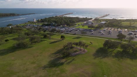 Right to left aerial view over Doug Jennings Park looking towards the ocean and sand pumping jetty, Gold Coast, Australia.