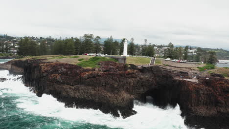 Aerial-drone-shot-of-the-Kiama-blowhole-and-headland-on-a-stormy-day-in-south-coast,-NSW-Australia