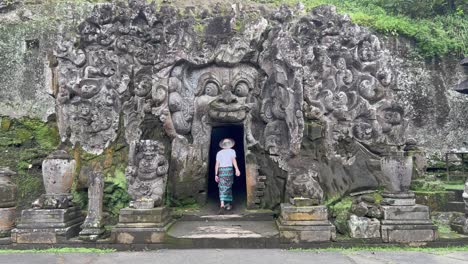 Journey-into-Mystery:-Male-Tourist-dressed-in-traditional-Balinese-Sarong-Explores-Goa-Gajah-Elephant-Cave,-one-of-the-holiest-temples-in-Ubud,-Bali