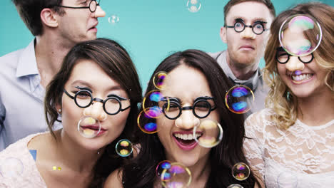 Multi-racial-group-of-people-wearing-false-noses-slow-motion-party-photo-booth