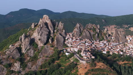 aerial drone of pietrapertosa, italy—mountain village built into rocky peaks, terracotta roofs, sweeping valley views. ideal for travel, tourism, culture, and cinematic landscape stock footage