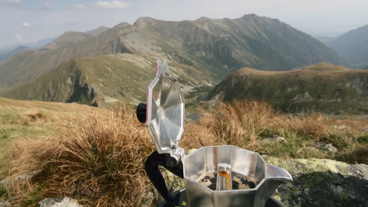 Making coffee in the mountains in moka pot, preparing coffee while camping on a sunny day