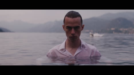 man in white shirt submerged in a lake