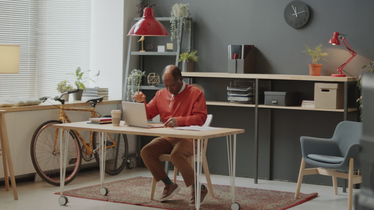 African American Businessman Beginning Workday in Office