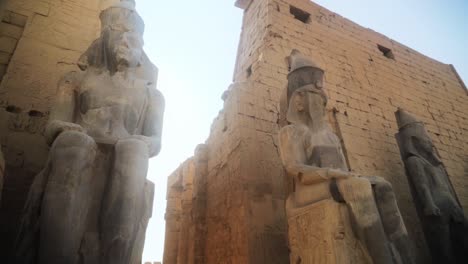 large statues of kings in the karnak temple of luxor, egypt.slow camera movement from a low angle