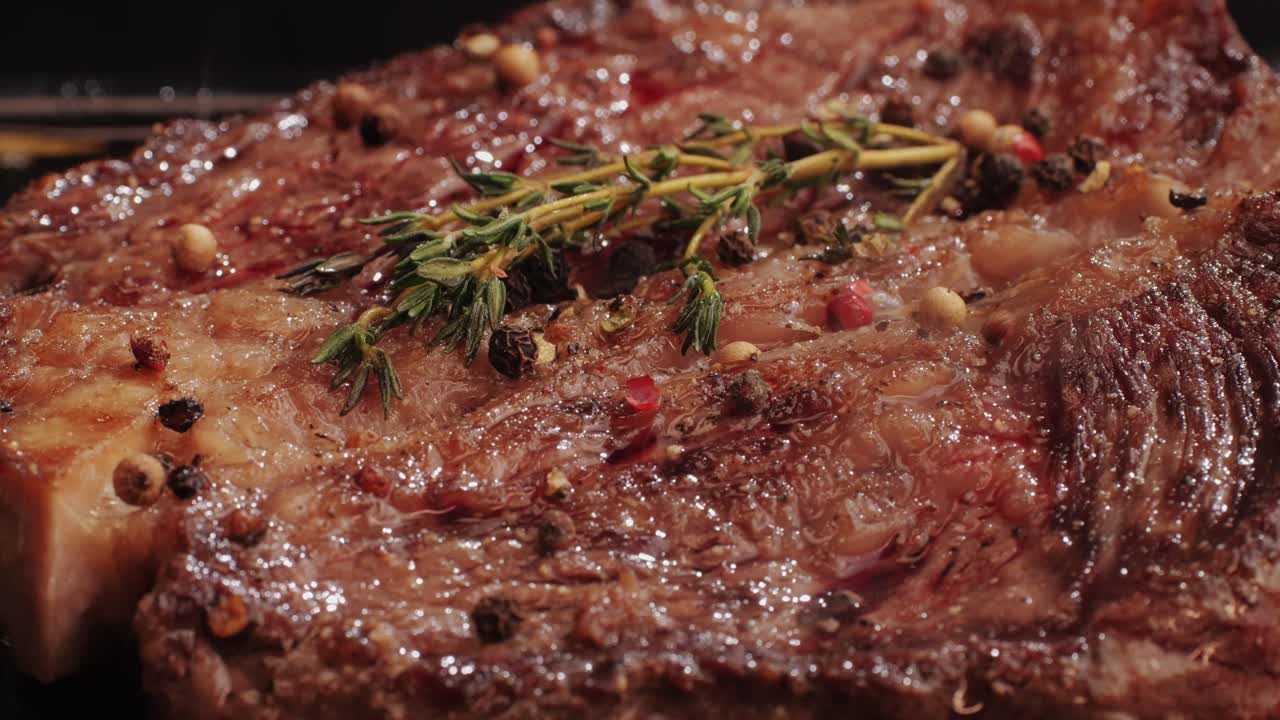 Fresh marbled beef with pepper, salt and rosemary close-up macro. Cooking juicy steak on grill with oil. Premium organic wagyu meat. High quality 4k footage