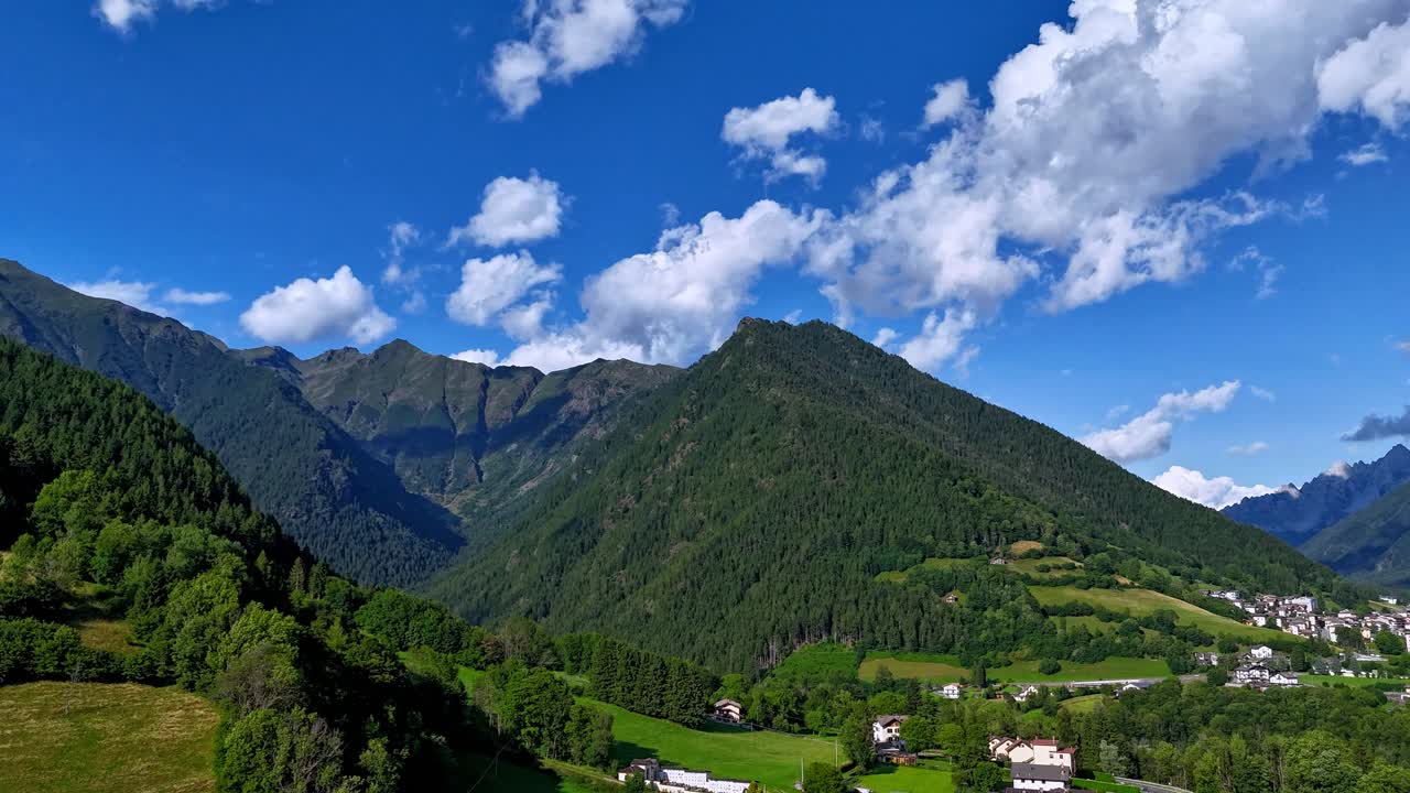 aerial drone hyperlapse flying over Val di Scalve. Majestic moving timelapse of the Orobie Alps mountain landscape in Italy with dynamic clouds