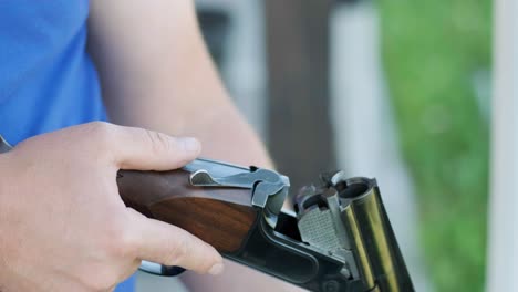 sportsman shoots from a double-barreled shotgun, a sports field for a shooting test is shooting at flying skeet