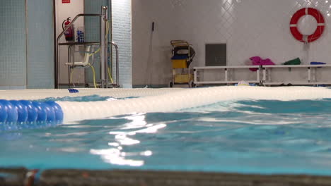 person swimming in an indoor pool