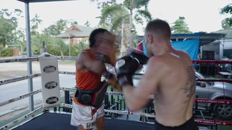 muay thai training session in a boxing ring