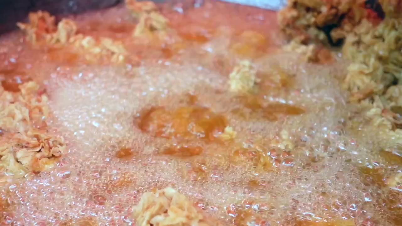 Crispy Chicken Pieces Frying in Hot Oil