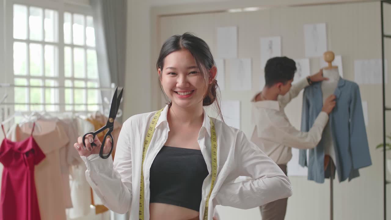 Young Asian Woman Tailor Holding Scissor And Smiling