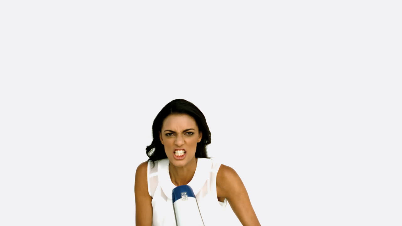 Angry businesswoman shouting on megaphone and jumping up
