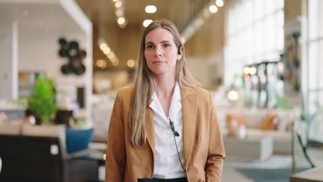 businesswoman strides aisle, sunlight streaming through windows, smiling at phone