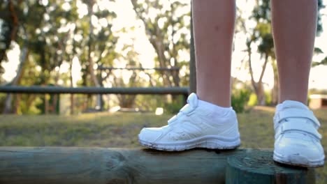 low section of kid walking on obstacle