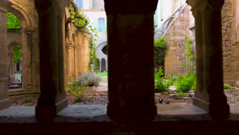 slow motion dolly shot of archways revealing the beautiful garden courtyard