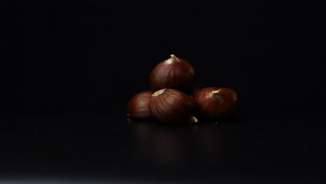 3-chestnuts-rotating-in-front-of-a-black-background