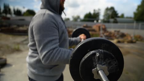 A-Man-Integrating-a-Barbell-Into-His-Workout-Routine---Close-Up