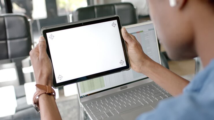 African american casual businessman laptop and holding tablet with copy space on screen, slow motion