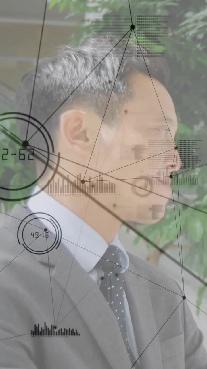 Vertical video: Mid-adult businessman hearing offscreen prompt, turning while HUD dials animating