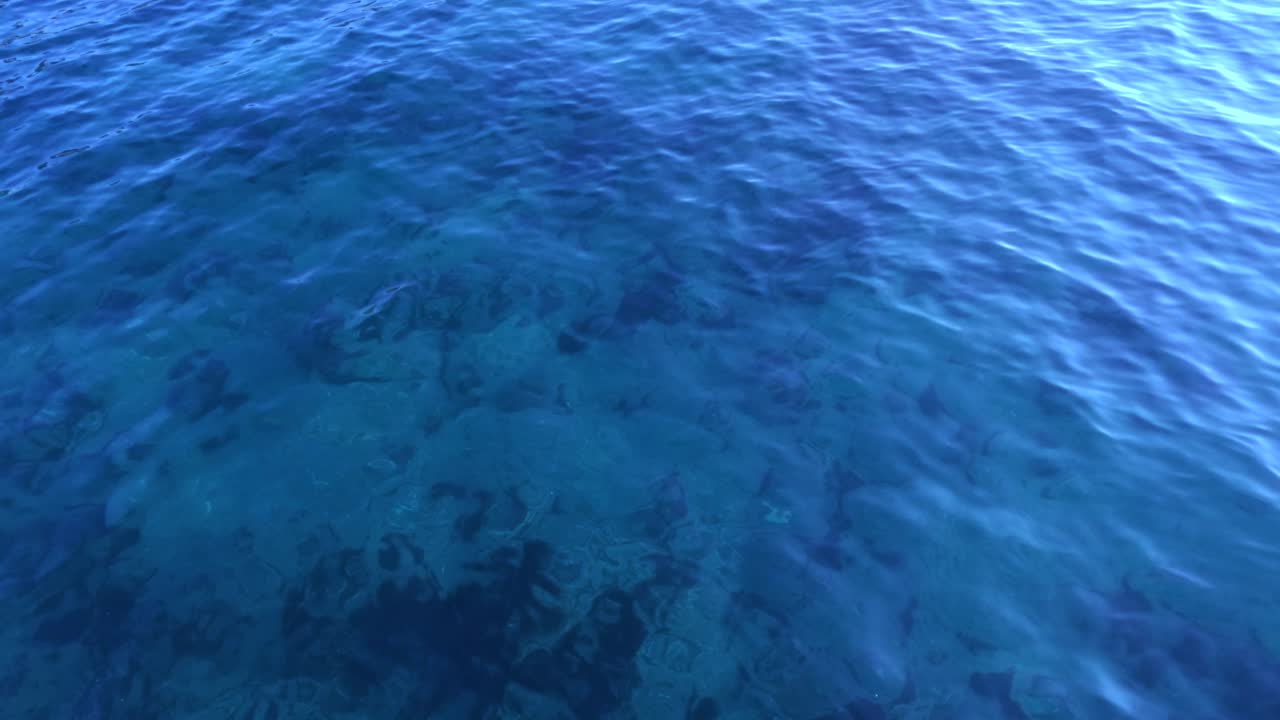 Waves gently moving over deep blue ocean