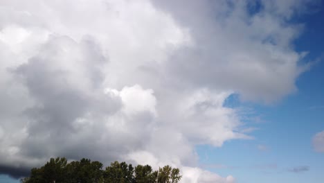 moving time lapse, hyperlapse of rolling storm clouds moving right to left, cumulonimbus