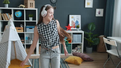 girl dancing in her room with headphones