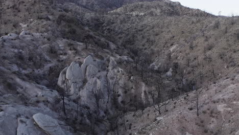 Contours-of-the-Devil's-Punchbowl-Arch,-backward-drone-shot