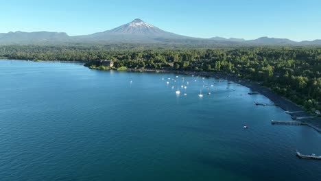 Aerial-Dolly-over-Villarrica-Lake-Hotel-Bay-to-the-Volcano,-Chile