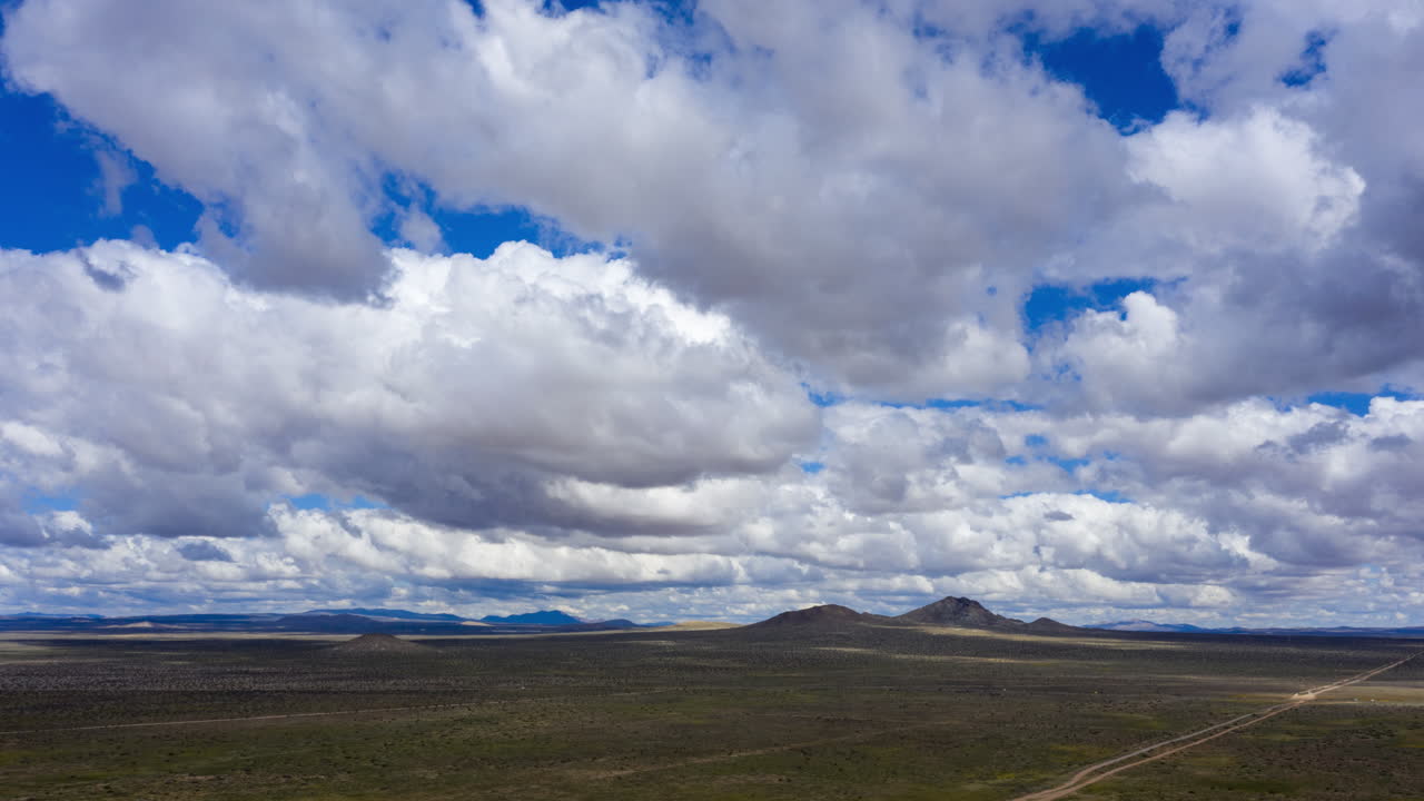 AERIAL Timelapse White Grey Clouds Passing Over Mojave Desert, Dolly In
