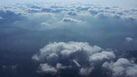 Camera-is-raising-above-from-the-thick-fog-above-the-beautiful-ocean-of-clouds