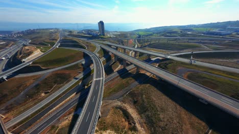 fpv sports drone flight of highway showing multiple roads, bridges, viaducts with little car traffic