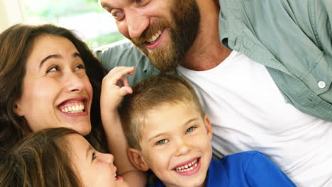 Happy-family-sitting-on-couch-